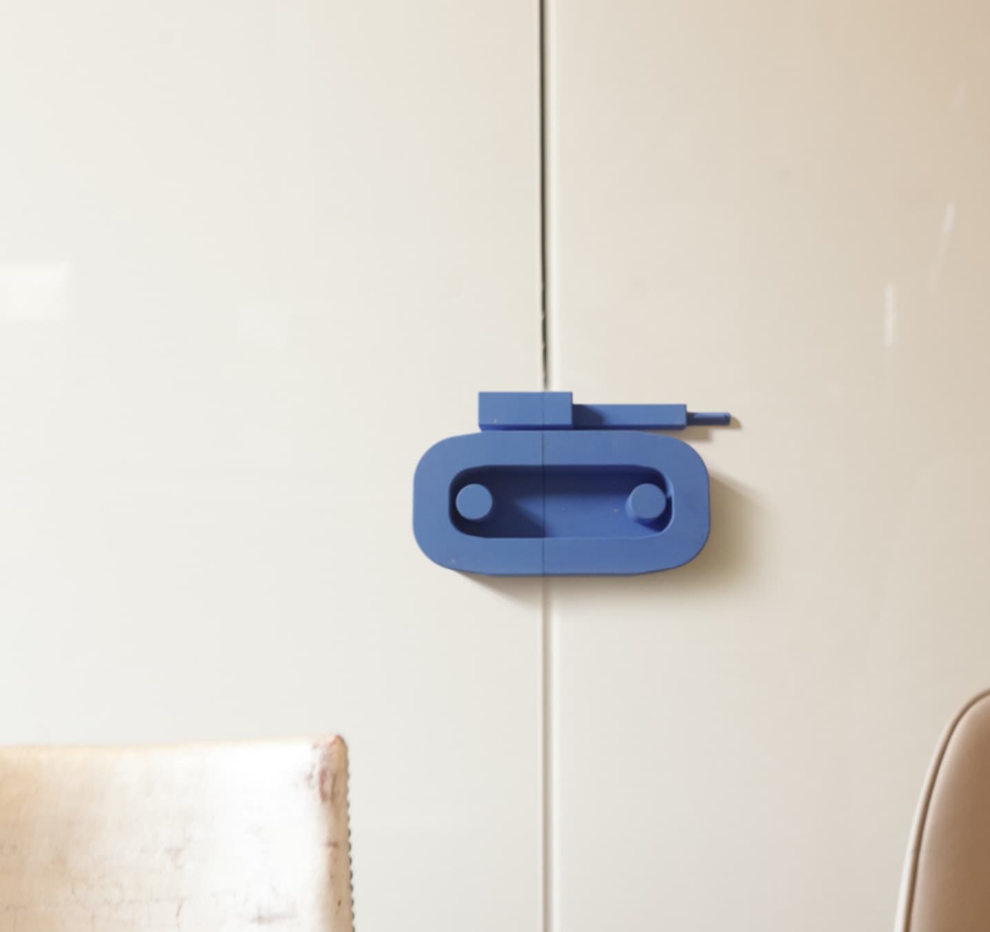 Blue design handle on lacquered cabinet